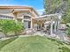 Well-maintained backyard with covered patio, outdoor dining, and a lush green lawn at 9517 Mountainair Ave, Las Vegas, NV 89134