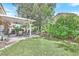 Green backyard with patio and outdoor seating area for entertaining at 9517 Mountainair Ave, Las Vegas, NV 89134