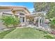 Green backyard with patio and outdoor seating area for entertaining at 9517 Mountainair Ave, Las Vegas, NV 89134