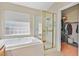 Primary bath featuring a separate tub, shower, and walk-in closet at 9517 Mountainair Ave, Las Vegas, NV 89134