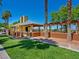Community center featuring a covered patio, landscaping and open grassy areas, designed for gatherings and recreation at 9517 Mountainair Ave, Las Vegas, NV 89134