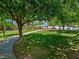 Lush green community park with walking path, mature trees and covered pavilion, perfect for outdoor activities and relaxation at 9517 Mountainair Ave, Las Vegas, NV 89134