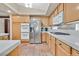 Bright kitchen features stainless steel appliances, tile floors, and light wood cabinetry at 9517 Mountainair Ave, Las Vegas, NV 89134