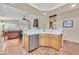Open living room with tile floors, breakfast bar, and access to backyard at 9517 Mountainair Ave, Las Vegas, NV 89134