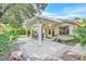 Charming covered patio featuring an outdoor dining area and lush landscaping at 9517 Mountainair Ave, Las Vegas, NV 89134