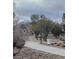 Picturesque community walking path with lush desert landscaping and a trash receptacle at 9517 Mountainair Ave, Las Vegas, NV 89134