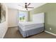 Well-lit bedroom with neutral walls, a white bed, and a ceiling fan at 7017 Pearl Hilltop Ct, Las Vegas, NV 89148