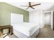 Bright bedroom featuring a white bed and a wooden side table at 7017 Pearl Hilltop Ct, Las Vegas, NV 89148