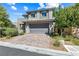 Charming two-story home featuring manicured landscaping, brick driveway, and a gray two-car garage at 7017 Pearl Hilltop Ct, Las Vegas, NV 89148