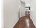 Open hallway with tile flooring leading to a kitchen with bar seating and modern lighting at 7017 Pearl Hilltop Ct, Las Vegas, NV 89148