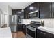 This kitchen features stainless steel appliances, subway tile backsplash, and dark wood cabinets at 7017 Pearl Hilltop Ct, Las Vegas, NV 89148
