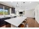 Open concept kitchen with a large island, pendant lighting, and stainless steel appliances at 7017 Pearl Hilltop Ct, Las Vegas, NV 89148