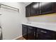The laundry room features dark cabinets and white quartz countertops with plenty of storage at 7017 Pearl Hilltop Ct, Las Vegas, NV 89148