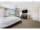 Spacious main bedroom featuring a king-size bed, mountain views, ceiling fan, and plush carpet at 7017 Pearl Hilltop Ct, Las Vegas, NV 89148