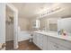 Main bath featuring double vanity, updated fixtures, and separate tub at 10001 Peace Way # 2322, Las Vegas, NV 89147