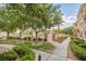Landscaped pathway leads to a community pool area, bordered by lush greenery, offering a scenic walk at 10001 Peace Way # 2322, Las Vegas, NV 89147