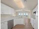 Modern eat-in kitchen featuring white cabinets, stainless steel appliances, and hardwood floors at 10001 Peace Way # 2322, Las Vegas, NV 89147