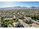 A neighborhood view of houses with tile roofs, landscaping, with the mountains in the background at 1013 Brinkman St, Las Vegas, NV 89138