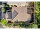 Aerial view of a home's tile roof and landscaped backyard with a privacy fence at 1013 Brinkman St, Las Vegas, NV 89138
