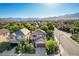 Elevated aerial view of the home featuring lush landscaping and a stunning mountain backdrop at 1013 Brinkman St, Las Vegas, NV 89138