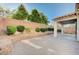 Large backyard with a covered patio, brick pavers, and a retaining wall, offering a serene outdoor space at 1013 Brinkman St, Las Vegas, NV 89138