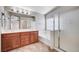 Bathroom features double sinks, a soaking tub under a window, and a glass enclosed shower at 1013 Brinkman St, Las Vegas, NV 89138