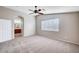 Spacious bedroom features plush carpeting, ceiling fan, neutral walls and bright light from a large window at 1013 Brinkman St, Las Vegas, NV 89138
