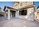 Back exterior with covered patio, slider, paver patio and neutral stucco at 1013 Brinkman St, Las Vegas, NV 89138