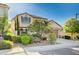 Two-story home showcasing meticulously maintained landscaping and a private, fenced front yard with mature trees at 1013 Brinkman St, Las Vegas, NV 89138