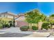 Charming home with lush landscaping, including mature trees and well-maintained bushes, enhancing curb appeal at 1013 Brinkman St, Las Vegas, NV 89138