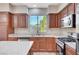 Kitchen counter with a window, stainless steel oven, and microwave at 1013 Brinkman St, Las Vegas, NV 89138