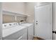 Laundry room with washer, dryer, and shelving at 1013 Brinkman St, Las Vegas, NV 89138