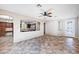 Open-concept living room featuring tile flooring, ceiling fan, and views into adjacent kitchen and dining area at 1013 Brinkman St, Las Vegas, NV 89138