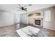 Inviting living room with a cozy fireplace, tile flooring, a ceiling fan, and a door leading to the outside at 1013 Brinkman St, Las Vegas, NV 89138