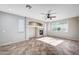 Open living room with tile flooring, a ceiling fan, a fireplace, and a large window, providing ample natural light at 1013 Brinkman St, Las Vegas, NV 89138