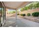 Spacious covered patio with brick pavers and a retaining wall, perfect for relaxing and enjoying the outdoors at 1013 Brinkman St, Las Vegas, NV 89138