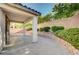 Covered patio featuring pavers and a block wall surrounded by mature landscaping at 1013 Brinkman St, Las Vegas, NV 89138