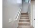 Carpeted staircase with white railing at 1013 Brinkman St, Las Vegas, NV 89138
