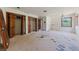 Spacious bedroom featuring unfinished flooring, natural light, and potential for customization at 112 Quail Run Rd, Henderson, NV 89014