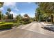 View of the entrance to the Quail Ridge Estates, lush landscaping and guardhouse at 112 Quail Run Rd, Henderson, NV 89014