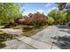 Expansive home featuring manicured landscaping, brick accents, and a circular driveway at 112 Quail Run Rd, Henderson, NV 89014