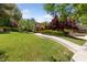 Lush front lawn leading to a home with manicured hedges and a stone walkway at 112 Quail Run Rd, Henderson, NV 89014