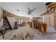 Open living room featuring a stone accent wall and ceiling fan at 112 Quail Run Rd, Henderson, NV 89014