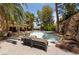 Outdoor pool area featuring tiled pool with lounge chairs for sunbathing by the water at 112 Quail Run Rd, Henderson, NV 89014