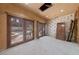 Renovated room with French doors and view of pool and stone fireplace at 112 Quail Run Rd, Henderson, NV 89014