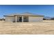 Exterior rear view featuring a covered patio, mountain view, and desert landscaping at 1131 Lupin St, Pahrump, NV 89048