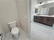A clean, modern bathroom with sleek white tile and a dark wood vanity, with white countertop at 1131 Lupin St, Pahrump, NV 89048