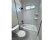 Updated bathroom showcasing a sleek, tiled shower-tub combination with modern fixtures at 1131 Lupin St, Pahrump, NV 89048