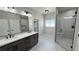 Bathroom features a double vanity, shower and tile flooring at 1131 Lupin St, Pahrump, NV 89048