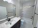 The modern bathroom features a double vanity, granite counters, and tiled shower-tub combo at 1131 Lupin St, Pahrump, NV 89048